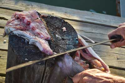 carcass cut into 3 inch strips on the chopping block